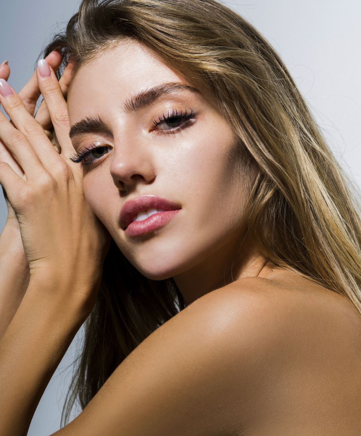 Model with long hair and soft facial features.