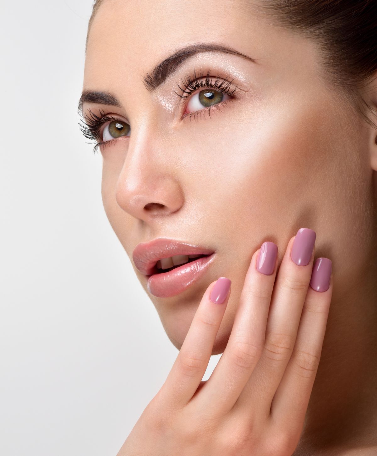 Close-up of woman with makeup and nails.