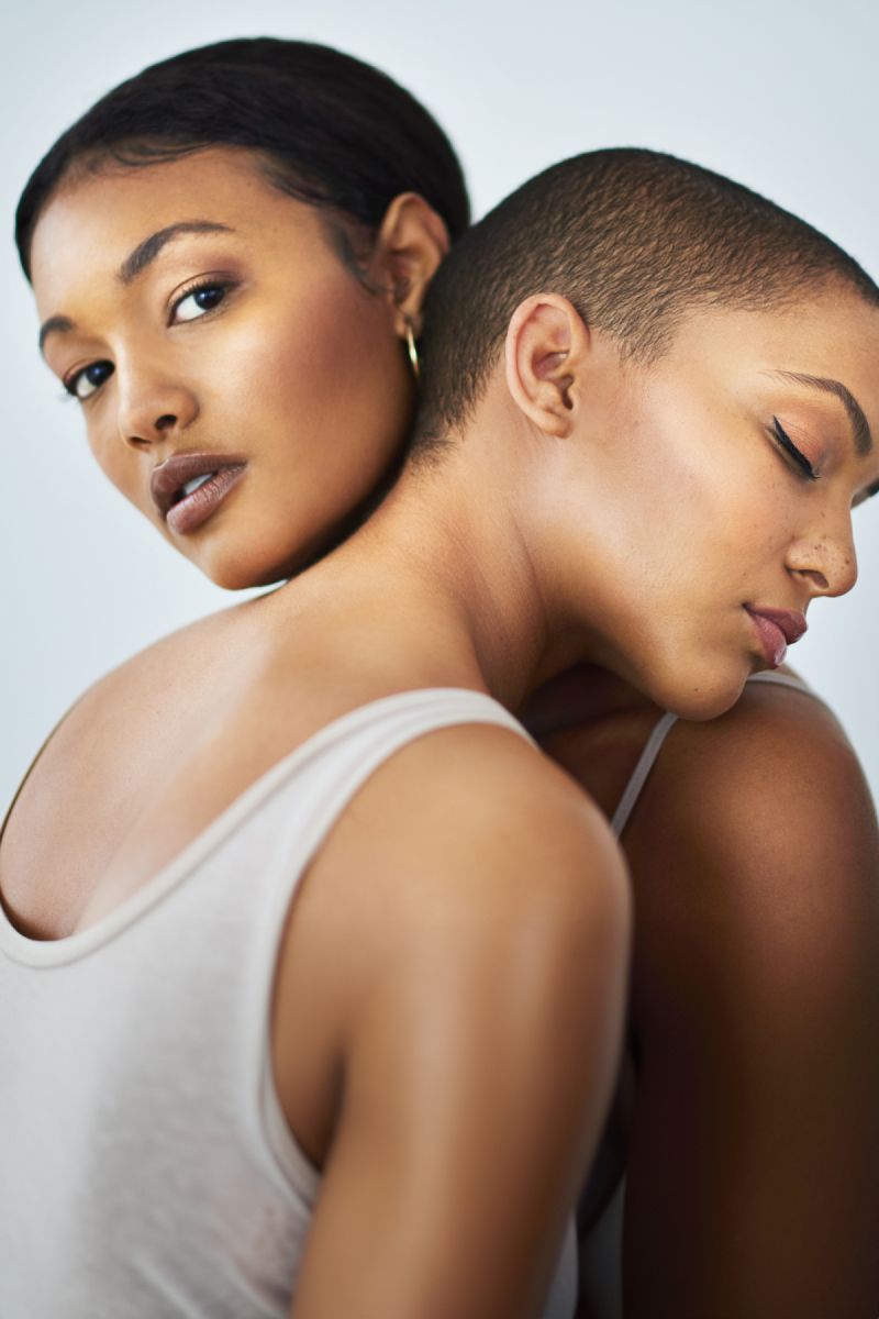 Two women embracing, showcasing confidence and beauty.