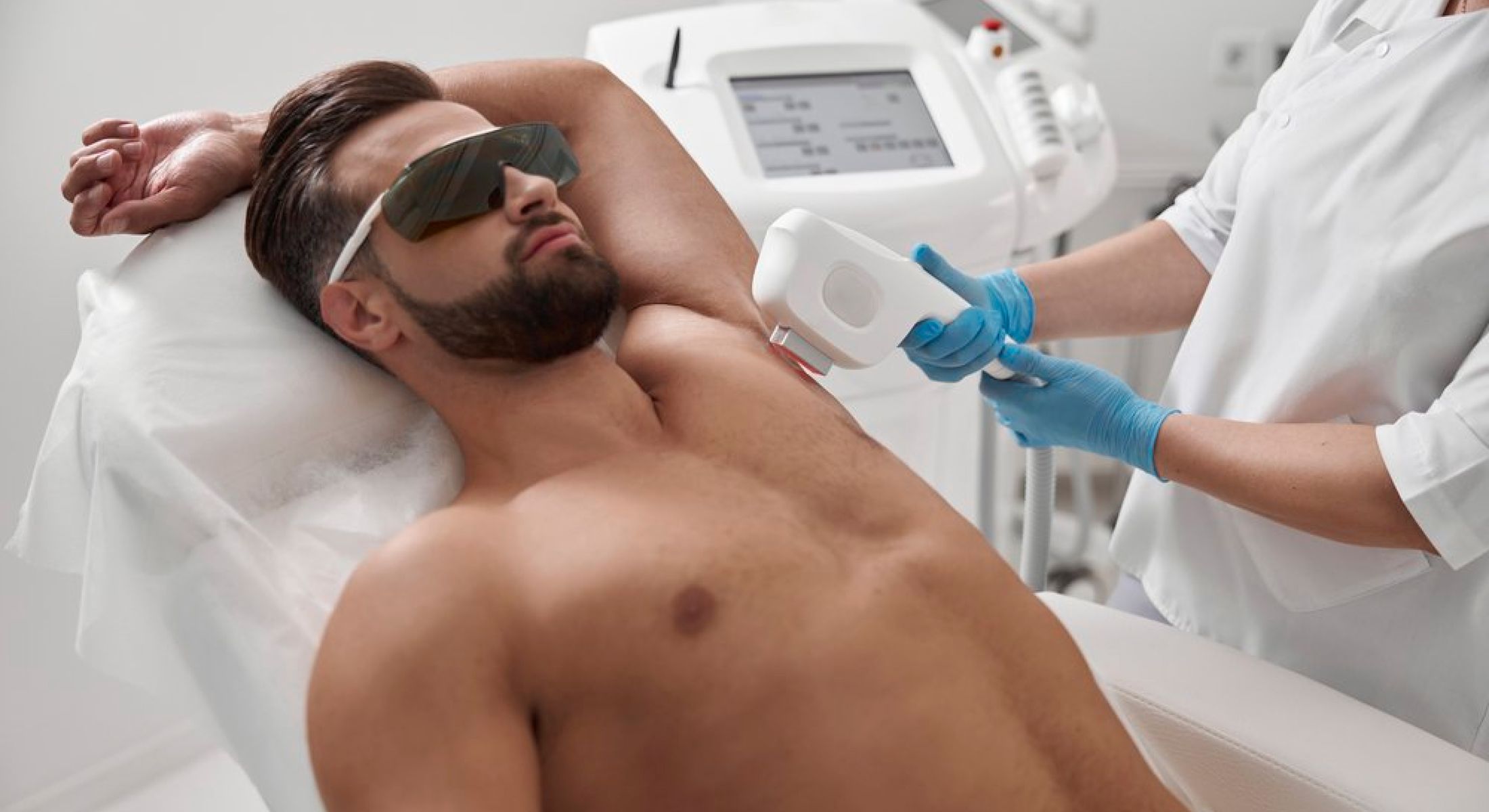 Man receiving laser hair removal treatment.